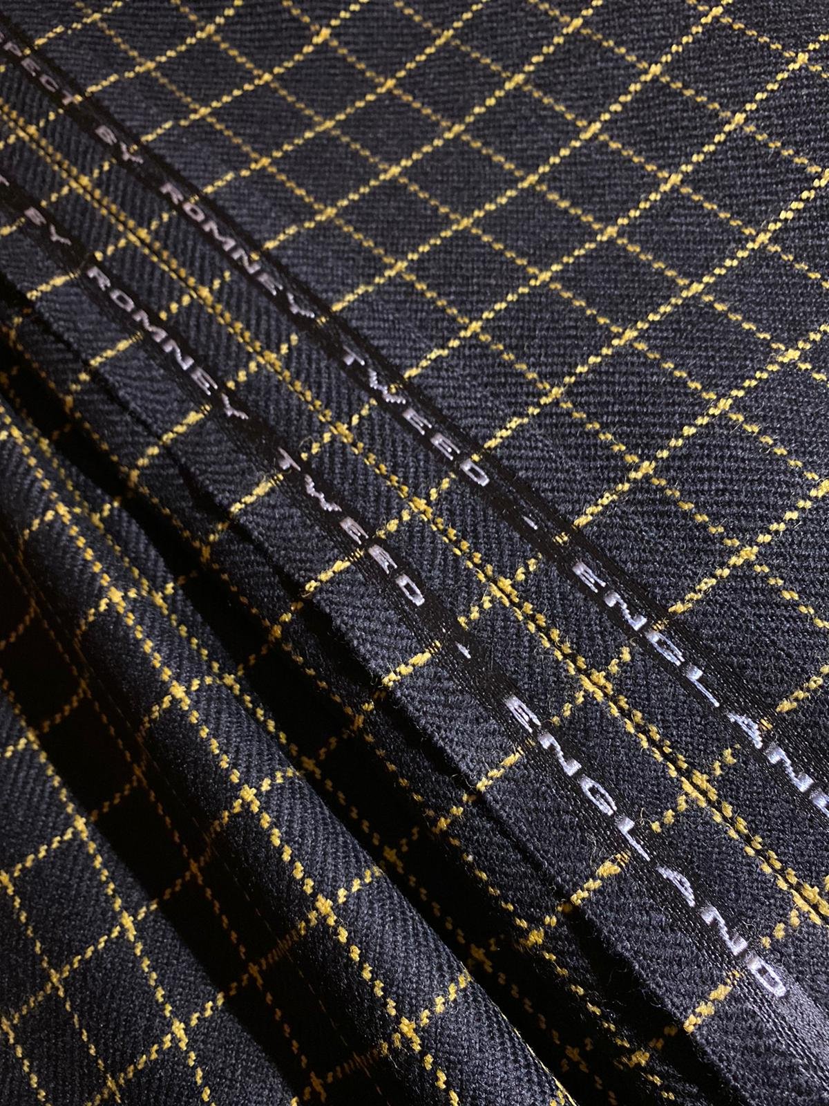 Close up image of black and yellow fabric that reads &