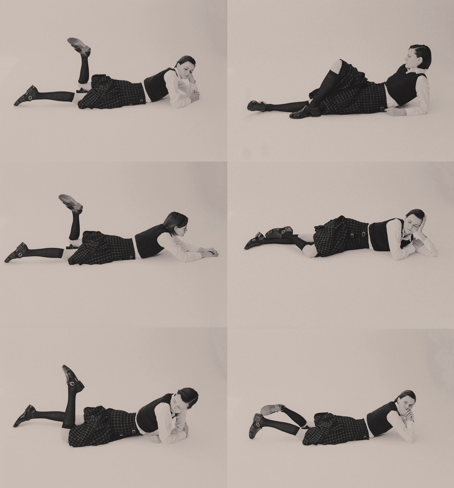 6 small black and white images of a model wearing a kilt lying on the floor
