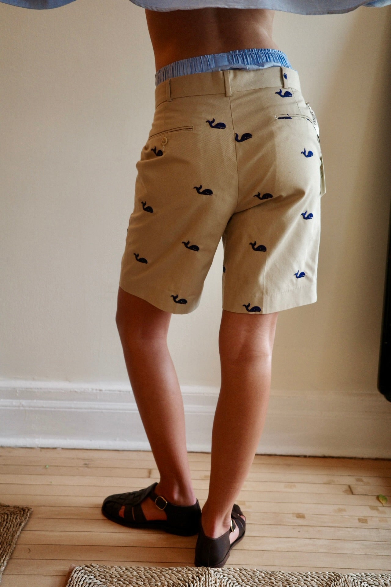 Woman with back to camera wearing khaki shorts
