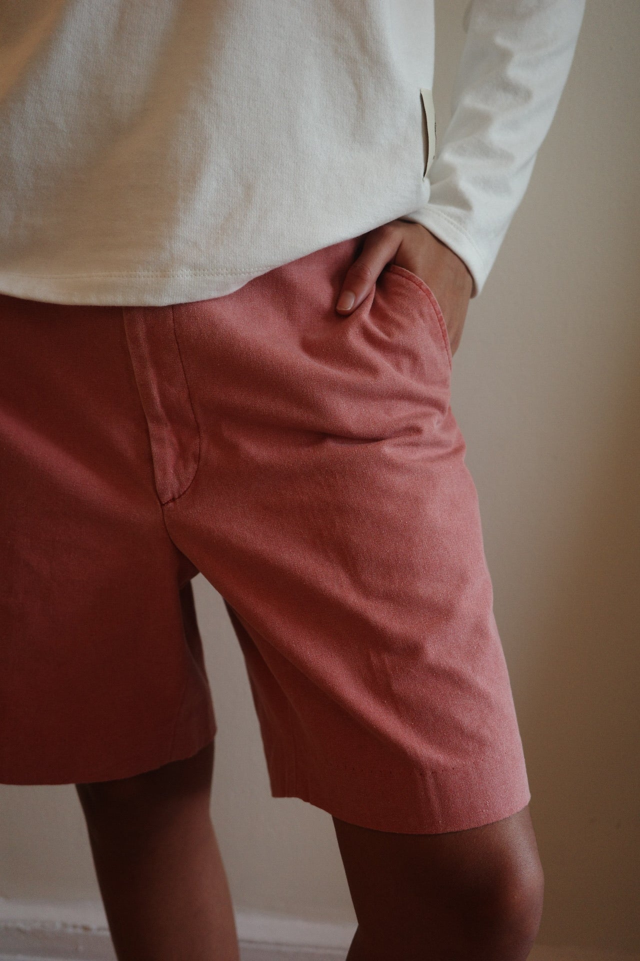 Close up shot of hand in pocket of red shorts