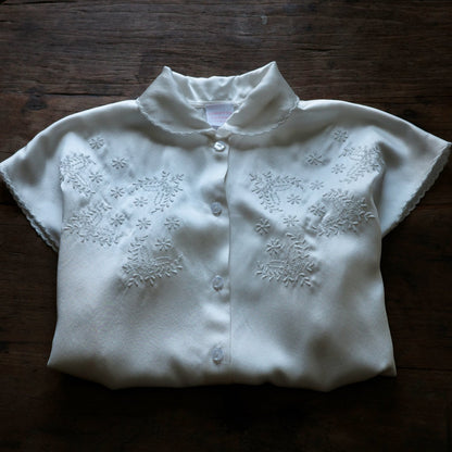 Folded Short sleeve collared shirt with floral embroidery.