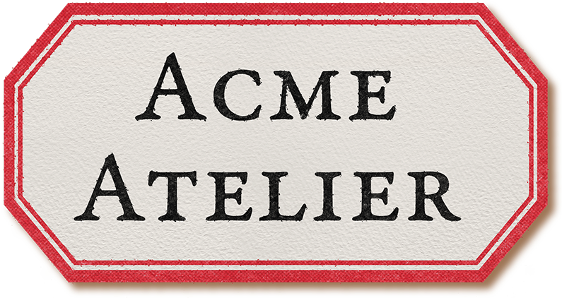 Rectangular sign with 'Acme Atelier' text on a white background